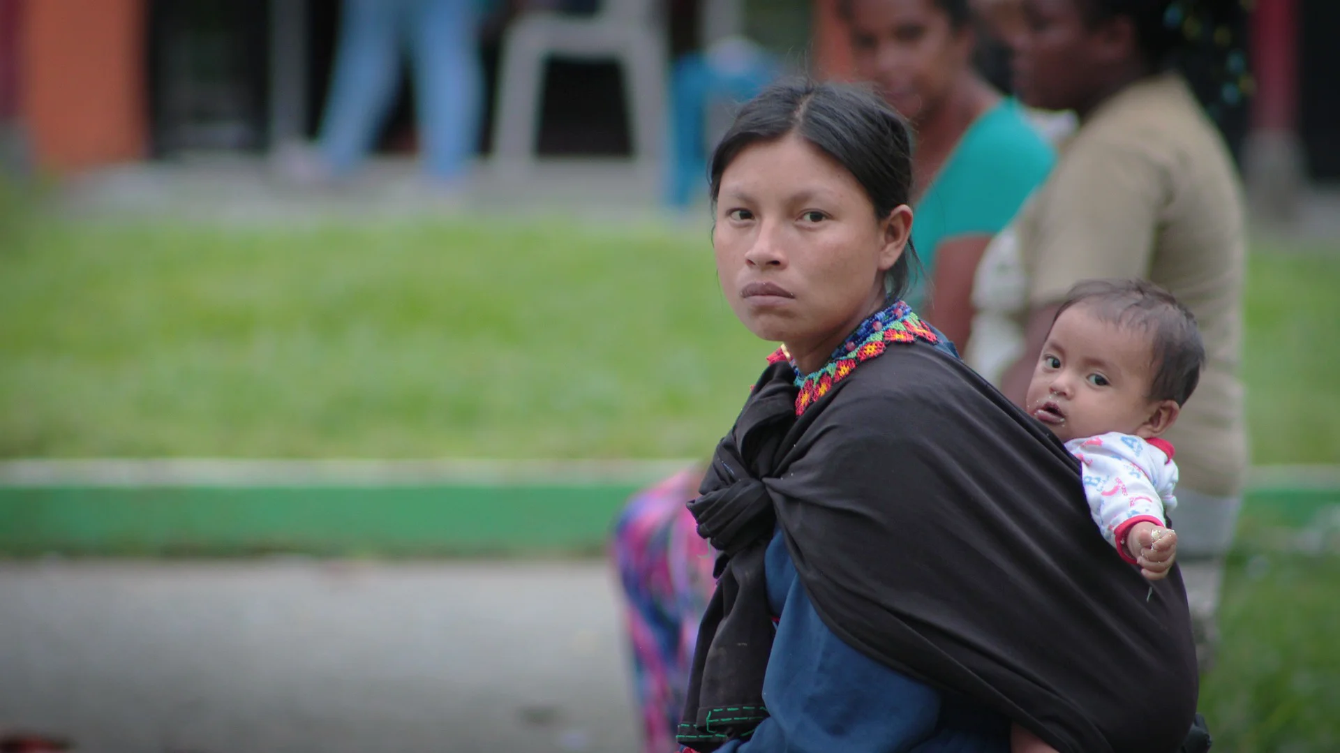 Colombian woman with baby strapped to her back